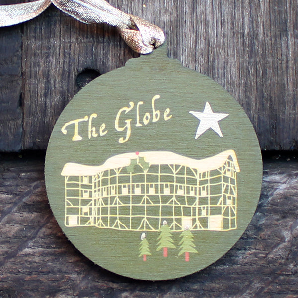 Green round wooden decoration with 'The Globe' and stylised drawing of the Globe Theatre on wooden background