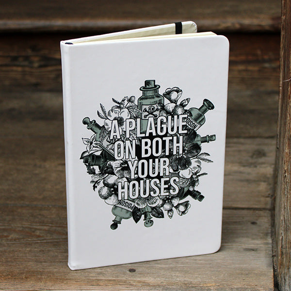 White hardback journal with a black and light green print on the cover.