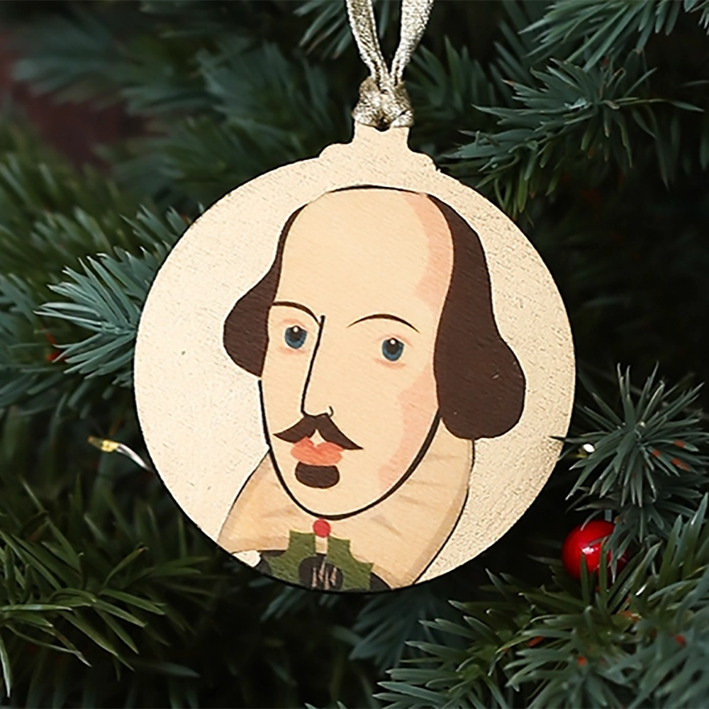 Round gold Christmas decoration with William Shakespeare portrait, hanging on a Christmas tree