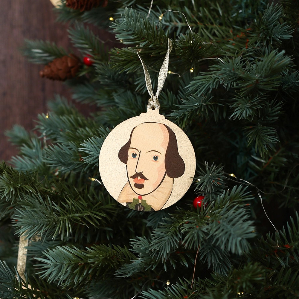 Round gold Christmas decoration with William Shakespeare portrait, hanging on Christmas tree