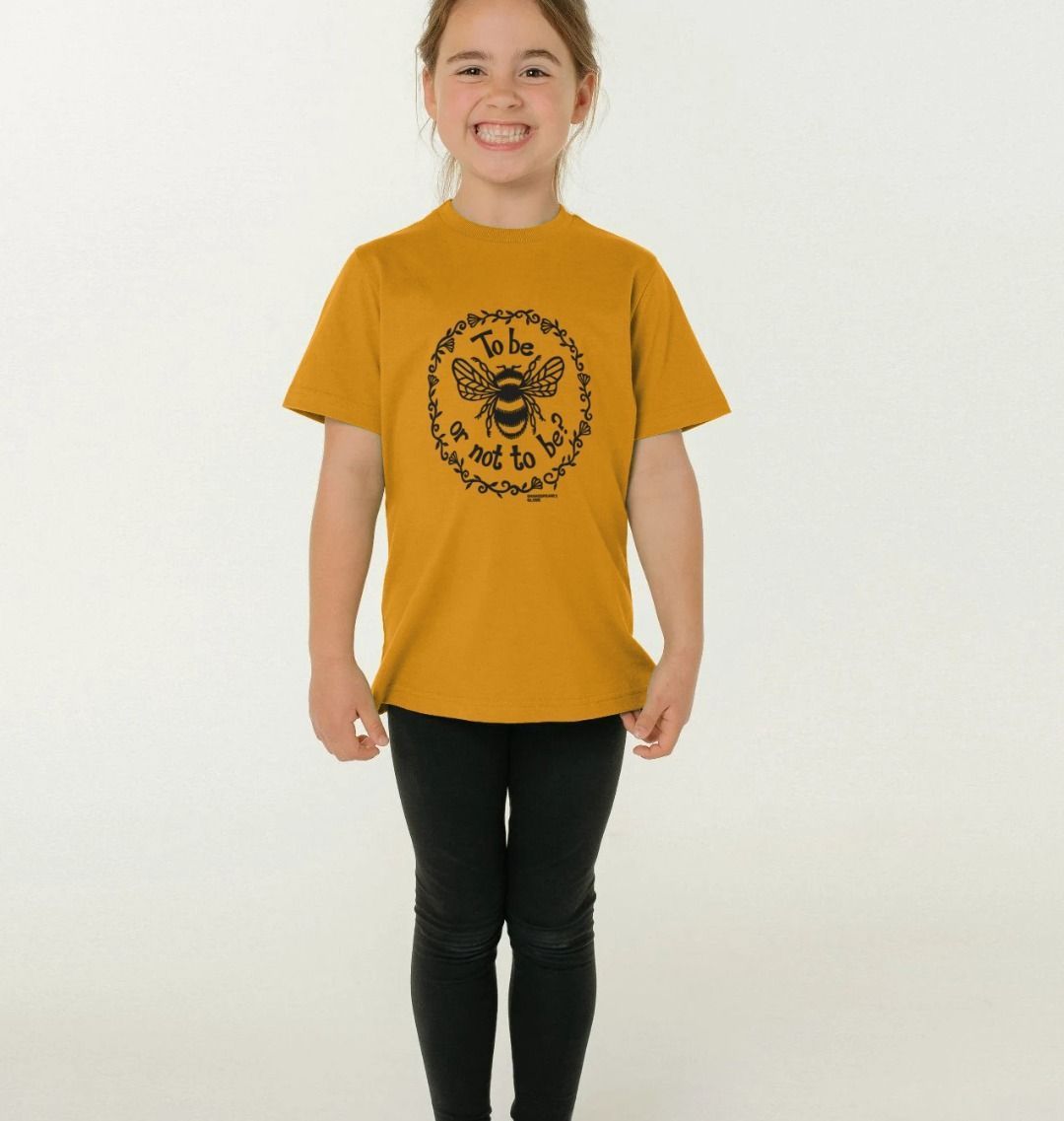 Young girl earing a mustard yellow t-shirt with a black print of a bumble bee with a quote around it