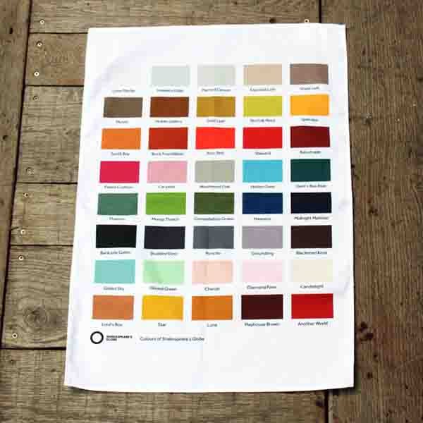 White cotton tea towel, portrait orientation with colour swatches in rows across, 5 per row, on wooden background