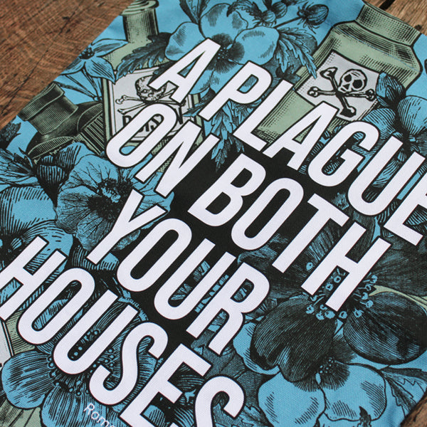 Powder blue cotton tote bag with two black handles, covered in gothic floral motif, with poison bottles, and white graphic text in centre