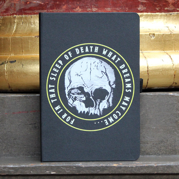 Black matt portrait orientated hardback journal with centre white skull graphic and surrounding text