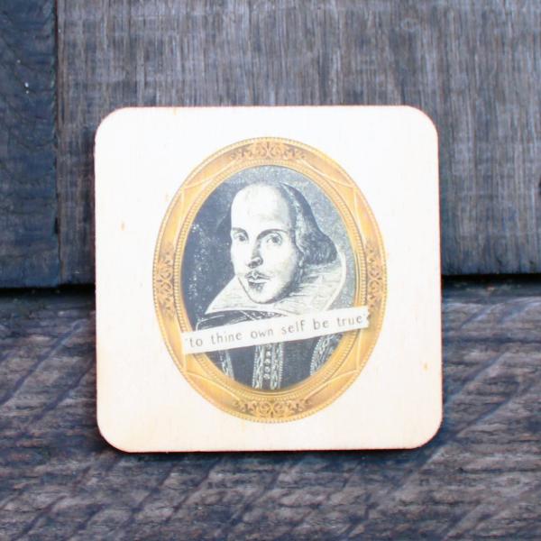 Wooden coaster with a black and gold print.