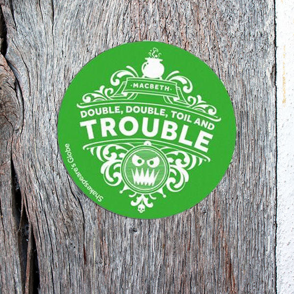 bright green circular sticker with a white print stuck to to wooden wall