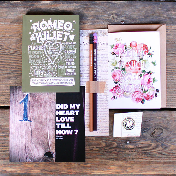 A selection of stationery products including pencils on a backing card, a green journal with white print, a black and gold pin badge, a purple and brown print and a floral greetings card