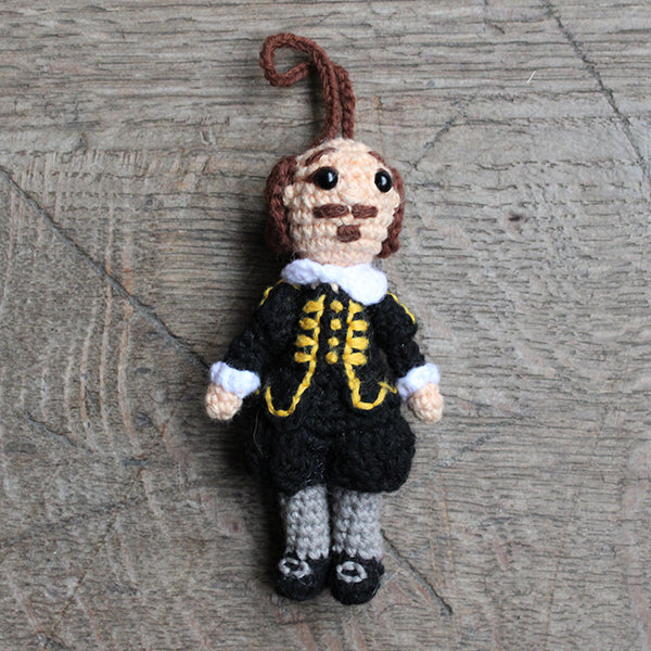 Crocheted Shakespeare decoration wearing a black doublet and hose with grey stockings