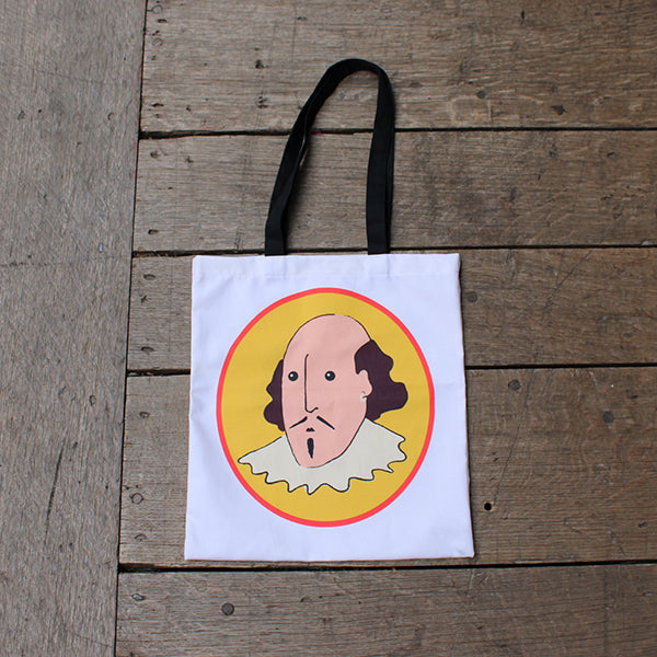 White cotton tote bag with 2 black handles and yellow oval portrait of cartoon shakespeare