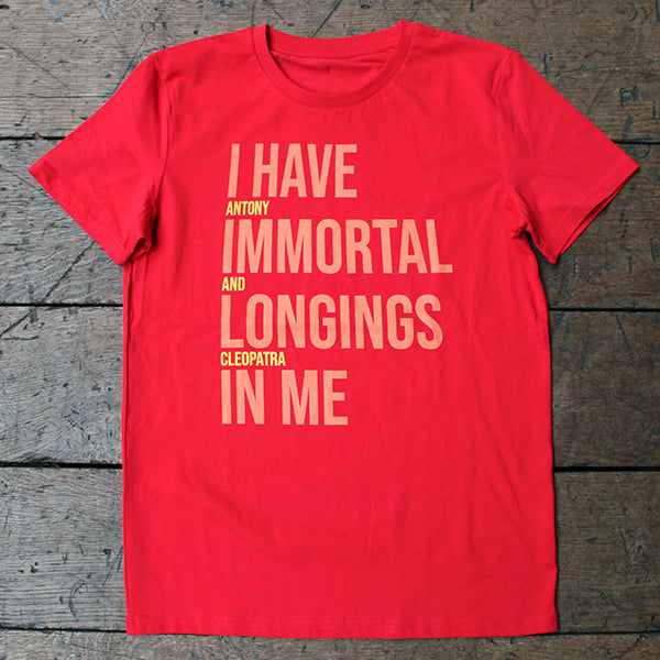Red graphic t-shirt with pale orange and bright yellow graphic text aligned to the left