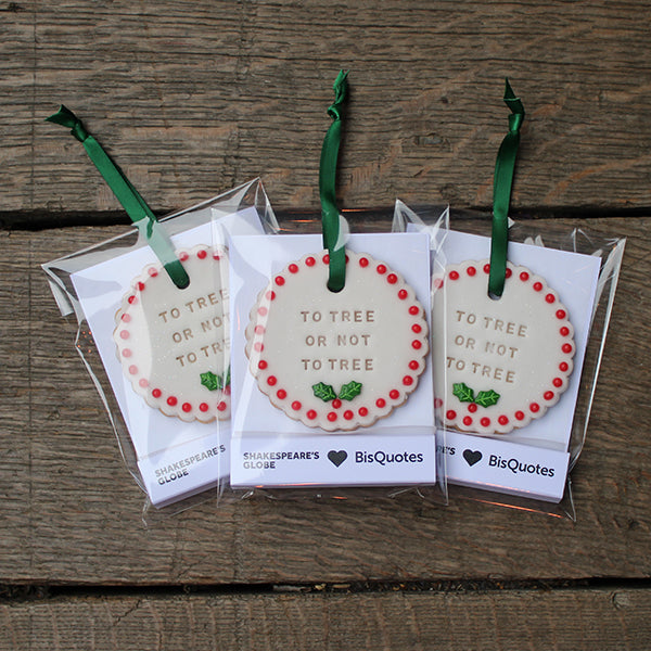 Three decorative Christmas biscuits with 'To Tree or Not to Tree' text on a wooden surface.
