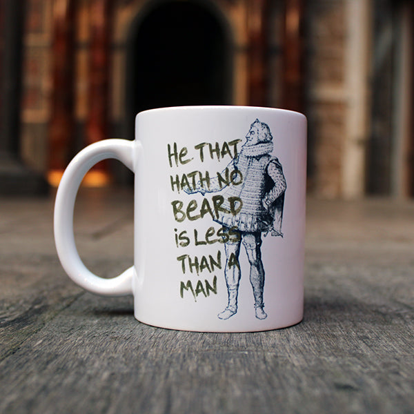 White ceramic mug with black graphic drawing of Shakespearean man with gold text overlayed
