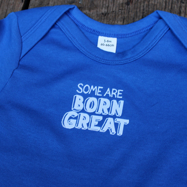 Royal blue cotton baby grow with short sleeve and white graphic text on centre front