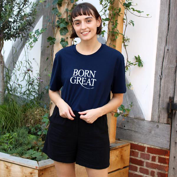 Young woman wearing a navy blue t-shirt with white text printed on the chest