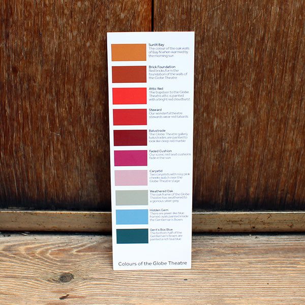 Card bookmark printed with blocks of colour sitting against a wooden background