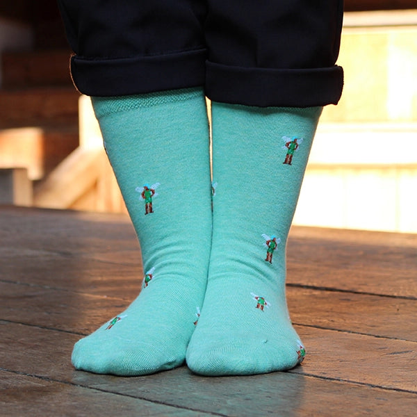 Teal cotton blend sock with repeating pattern of fairy from A Midsummer Night's dream, spaced an inch apart from one another