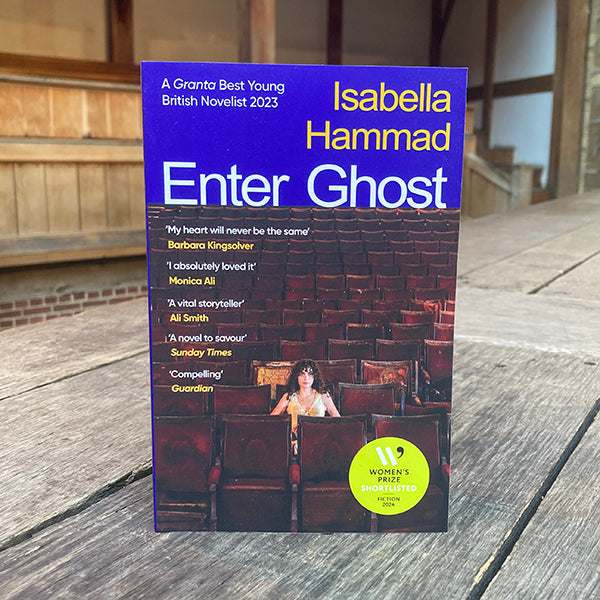 Book titled 'Enter Ghost' by Isabella Hammad on a wooden surface