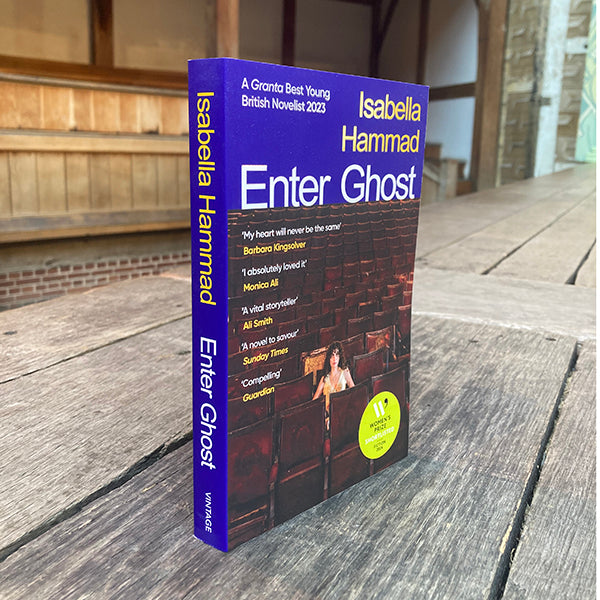 Book titled 'Enter Ghost' by Isabella Hammad on a wooden surface