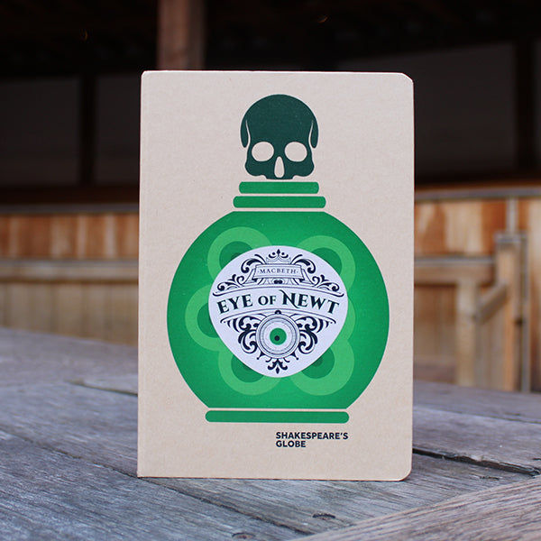 kraft notebook printed on the cover with a green potion bottle with an ornate white label