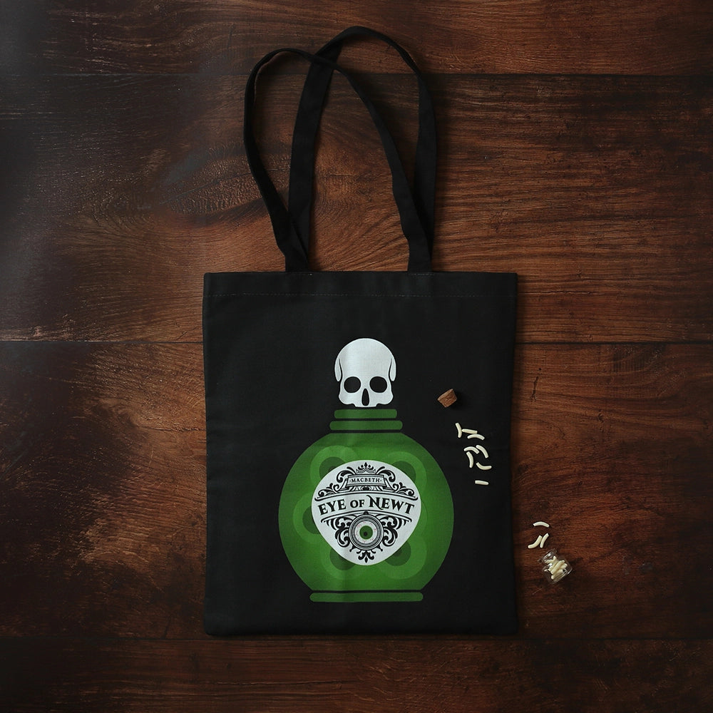 Steely grey tote bag with 2 black handles and green potion bottle with white skull top graphic