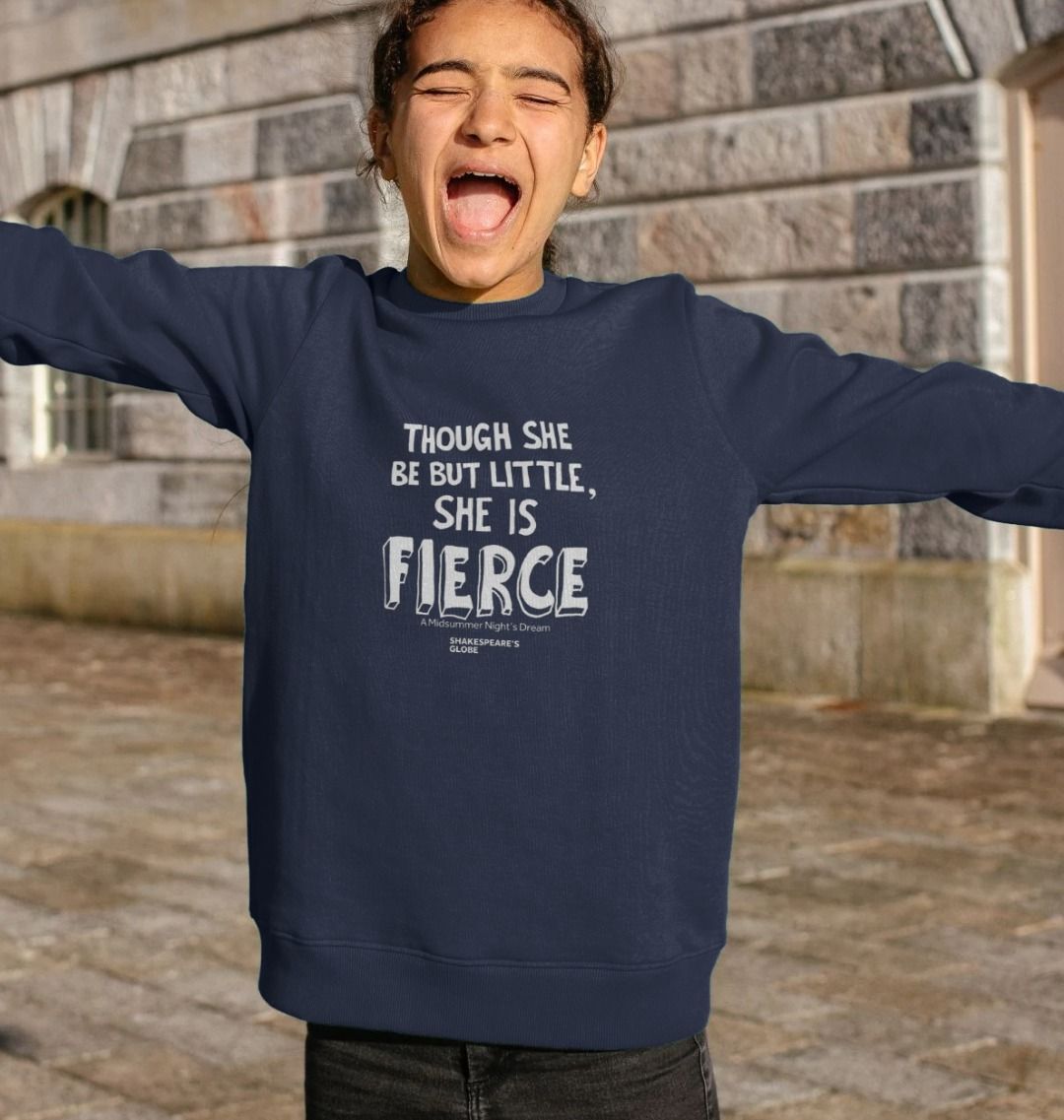 A young girl wearing a anvy blue sweatshirt with a white text print on the front