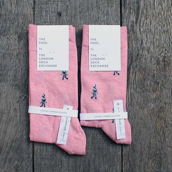 Pale pink cotton blend socks with fool character repeat pattern approximately 1 inch between each character, packaged in white card
