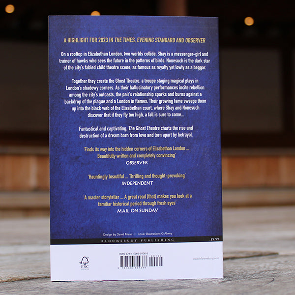 
                  
                    Royal blue paperback book with white and gold writing
                  
                