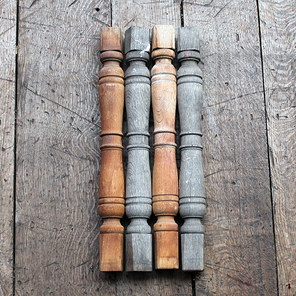 Set of wooden balusters in two colors on a wooden surface