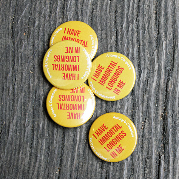 bright yellow button badge with red text