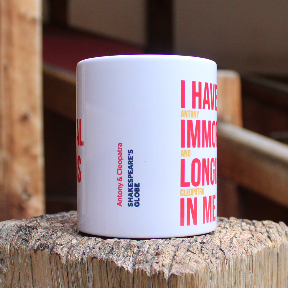 White ceramic mug with a red and yellow text print