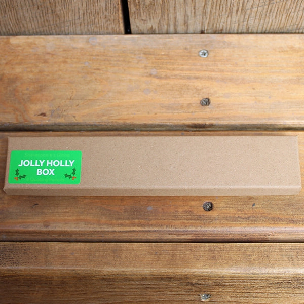 Natural card box with four pencils, from top to bottom, red, green, white, silver, all featuring a Christmas themed Shakespearean quote