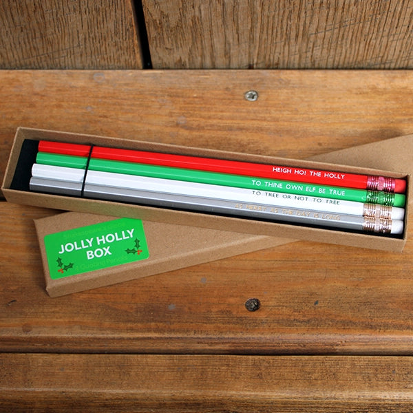 Natural card box with four pencils, from top to bottom, red, green, white, silver, all featuring a Christmas themed Shakespearean quote
