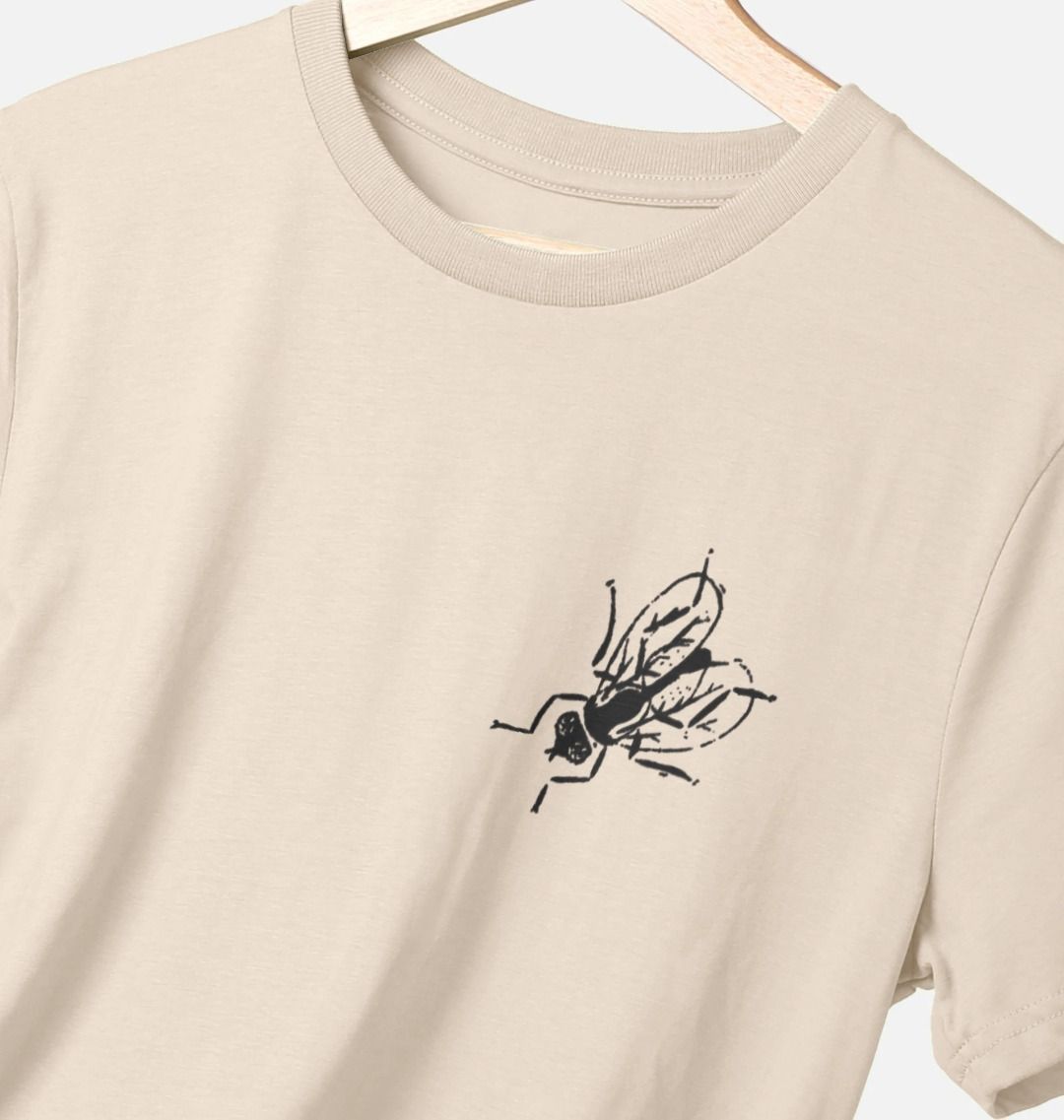 Standard fit cotton t-shirt with black fly graphic on upper left chest on oat t-shirt