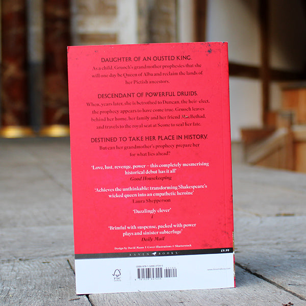 Red paperback book with gold and white graphic imagery and white text
