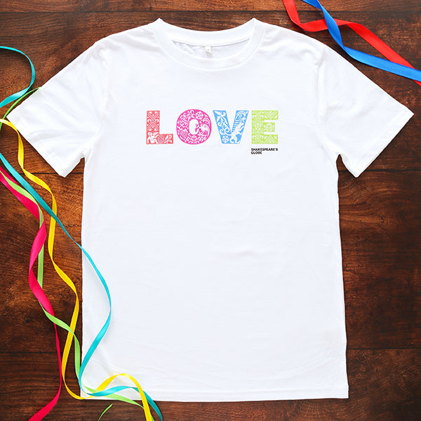 White Rainbow Love Organic Unisex T-shirt, standard fit, with orange, pink, blue, green L O V E, on wooden background with multi coloured ribbons