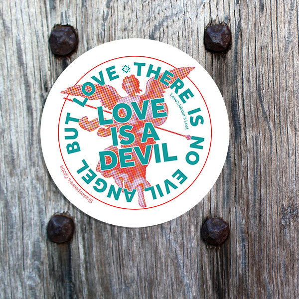 Circular sticker with text and angel illustration on a wooden surface
