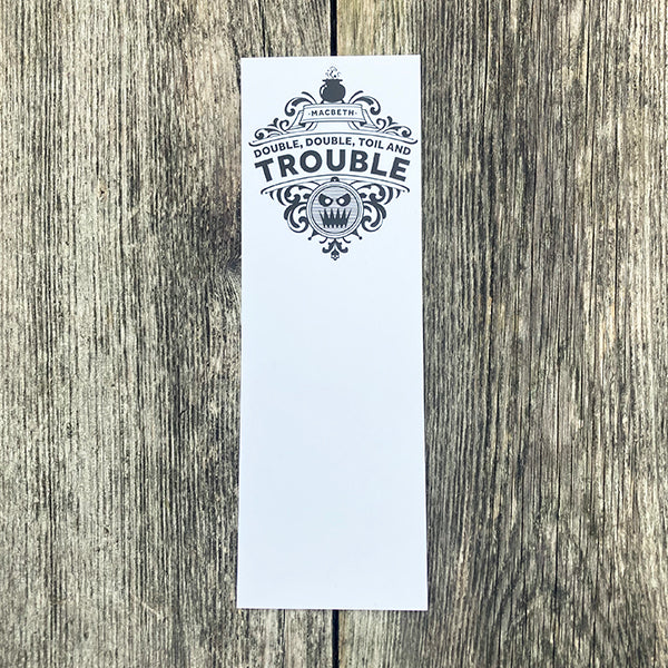 White card with black text and design on a wooden surface