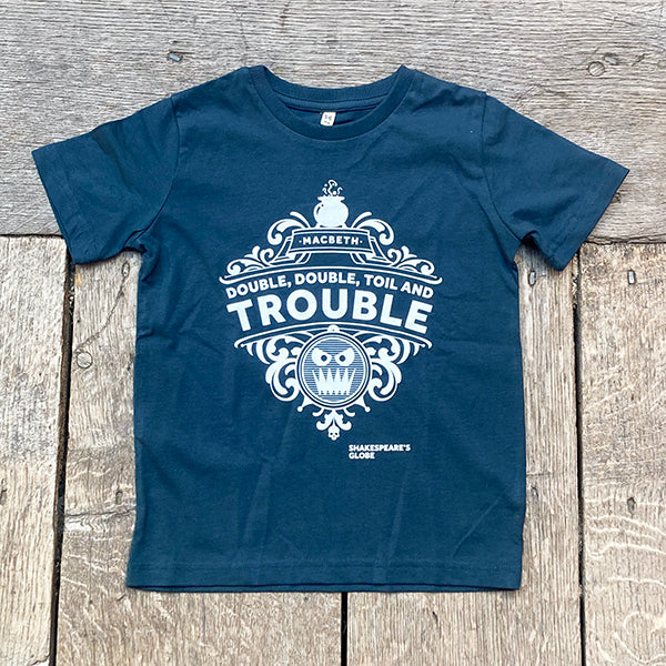 Denim blue t-shirt with white graphic design on a wooden surface