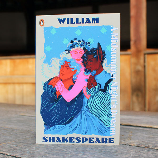 Book cover of 'A Midsummer Night's Dream' by William Shakespeare with colorful illustration on a wooden surface.