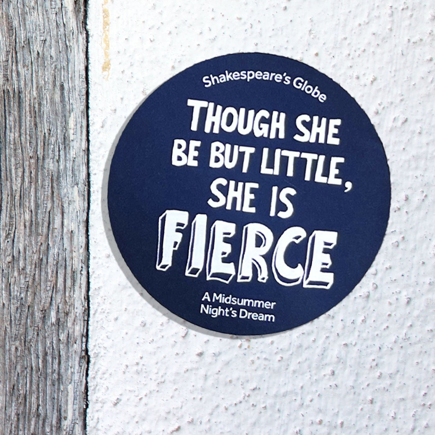 Round blue coaster with white text on a textured surface