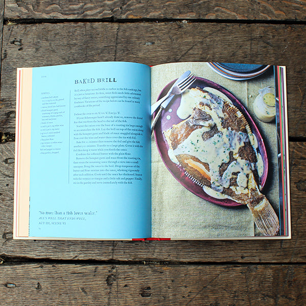Open cookbook on a wooden surface with a recipe for baked brill