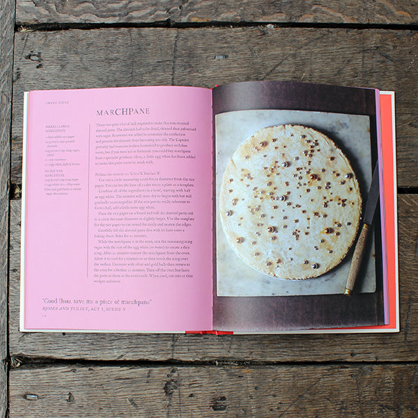 Open cookbook on a wooden surface with a recipe for marchpane
