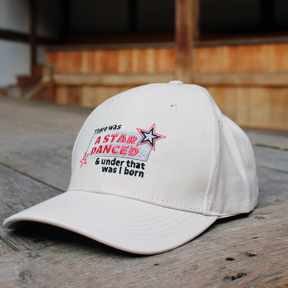 Sand coloured cotton baseball cap with red, black, and silver embroidery on the front