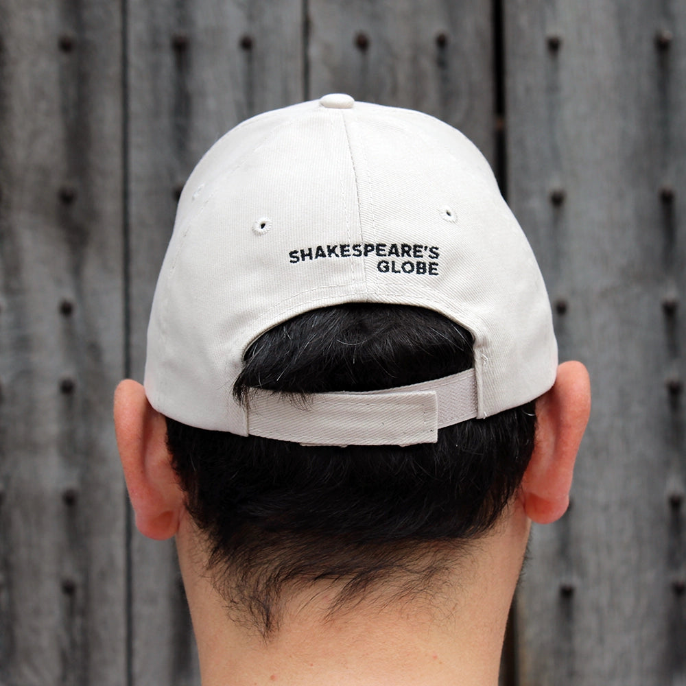Sand coloured cotton baseball cap with red embroidered lettering on the back