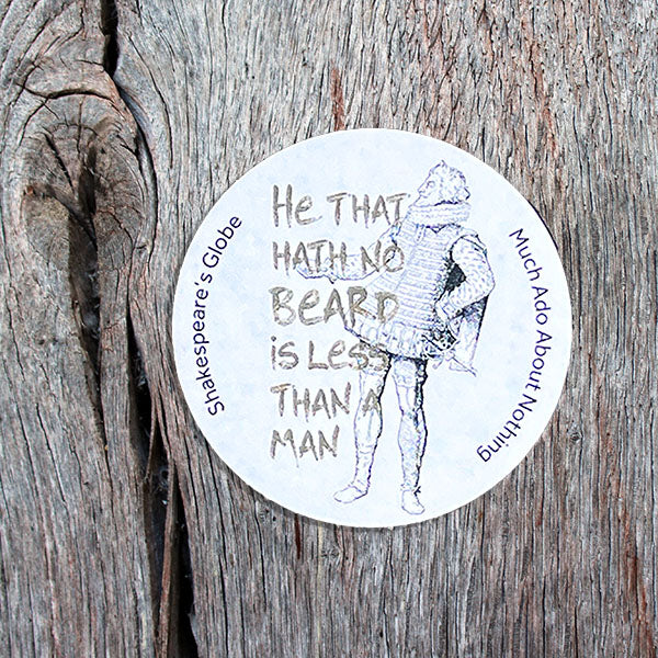 Circular sticker with Shakespearean text and illustration on a wooden surface