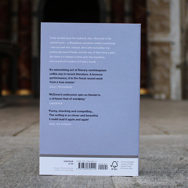 Pale blue grey paperback book with black and white text