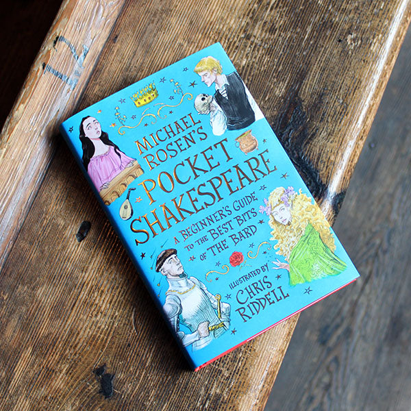 book with a blue cover featuring illustrations of figures in costume lying on a wooden bench