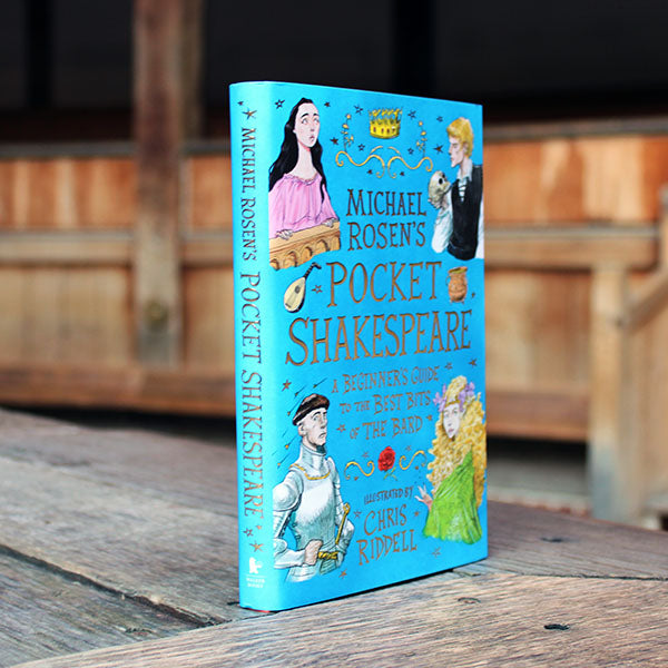 book with a blue cover featuring illustrations of figures in costume, book is at an angle showing spine