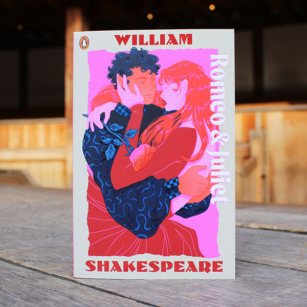 Book cover of 'Romeo & Juliet' by William Shakespeare on a wooden surface.