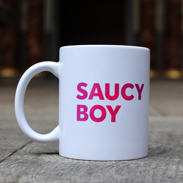 White mug with gradient dark to light pink text graphic in centre front, graphic repeated on both sides of the mug